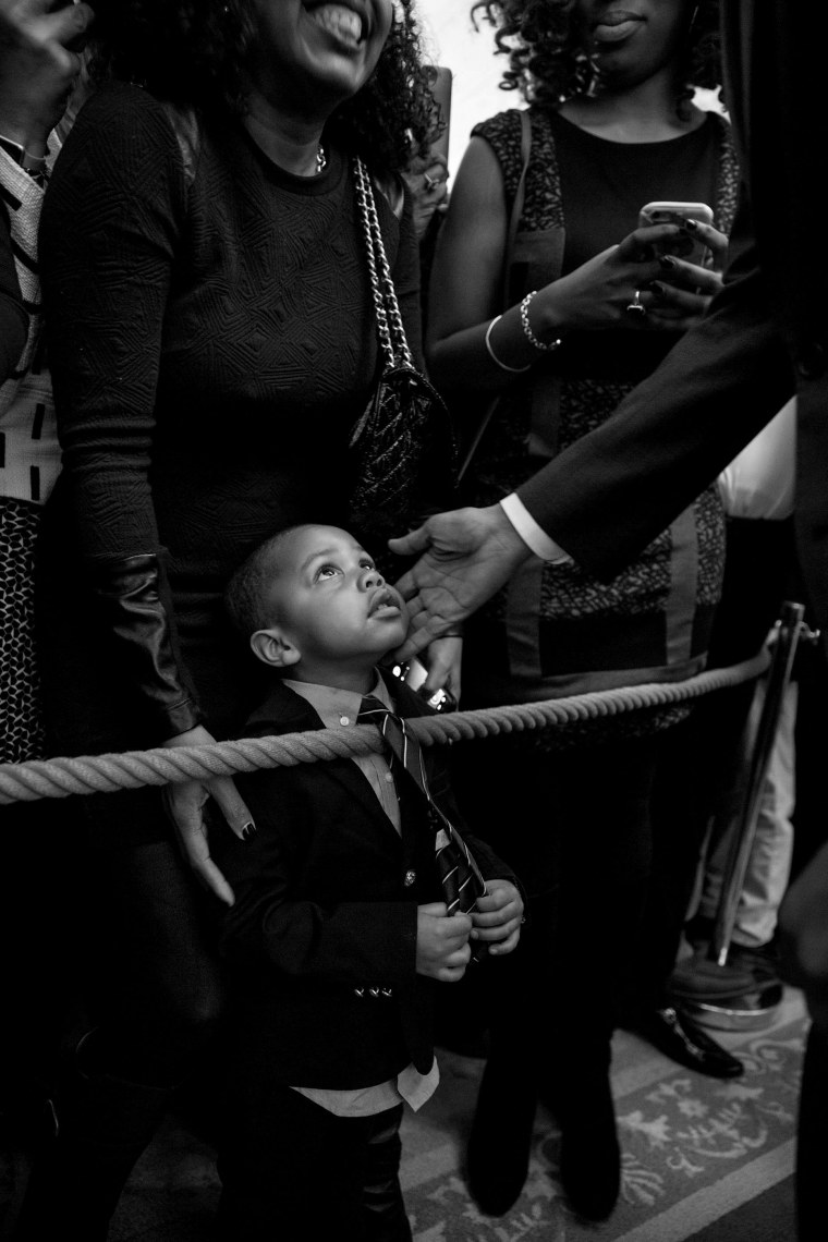 Image: President Barack Obama greets a young guest during a reception celebrating African American History Month