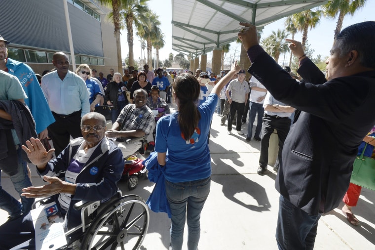 Image: Congressman Tony Cardenas, right, from California encourages Hillary Clinton caucus goers