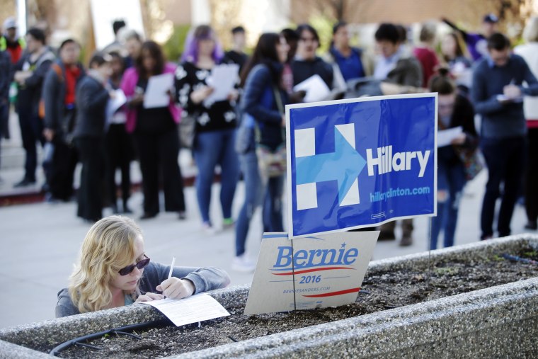 Image: Kara Bonham, at left, registers to vote for the Democratic caucus