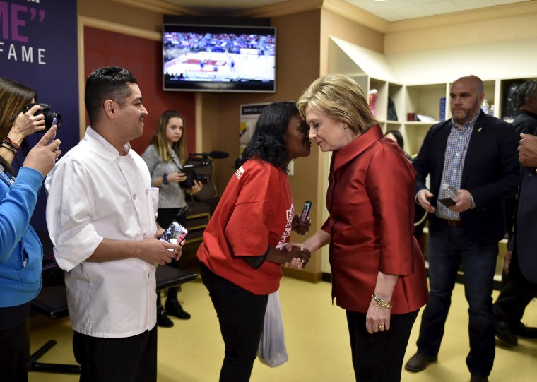 Image: Clinton meets employees during a campaign stop on caucus day