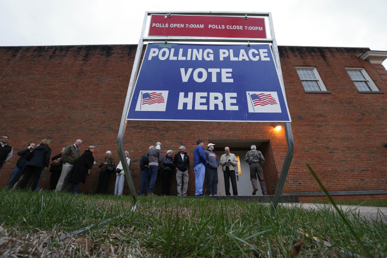 Image: Voters wait in line for a polling place to open at Eastlan Baptist Church