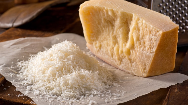 opening a wheel of parmesan cheese (parmigiano reggiano) 