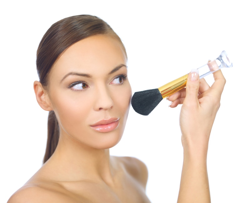 woman applying makeup with brush