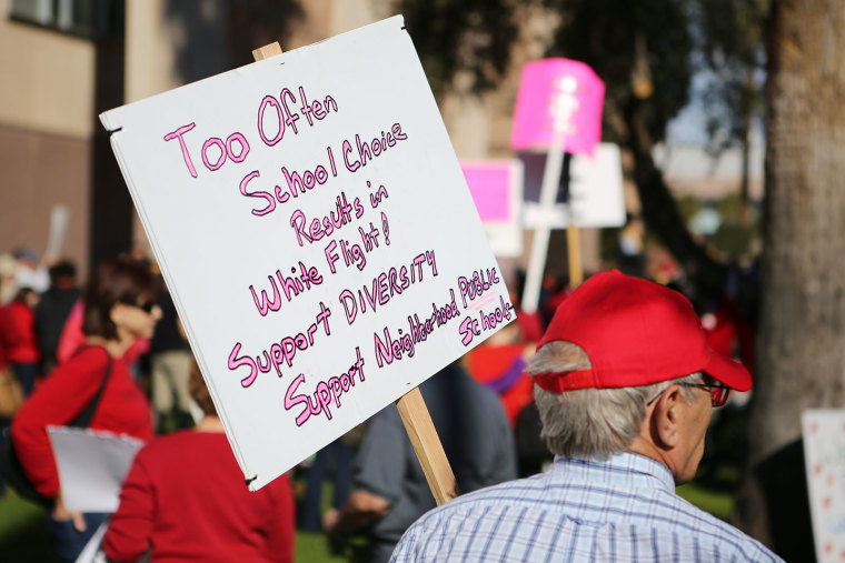 Demonstrators at a school choice rally held at the Arizona Capitol displayed various signs supporting both charter and district public schools in Arizona on Friday, Jan. 29, 2016.