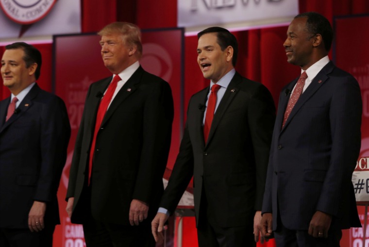 Image: Republican U.S. presidential candidates Cruz, Trump, Rubio and Carson pose together at the start of the Republican U.S. presidential candidates debate sponsored by CBS News and the Republican National Committee in Greenville