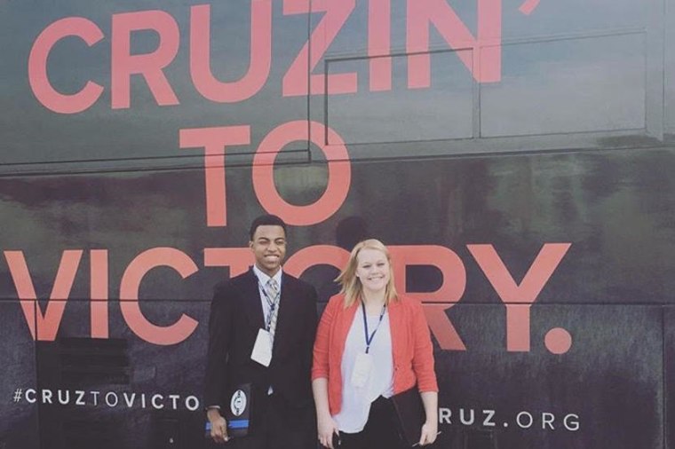 \"Chase the Race\" reporters Mikayla Kelz and Charles Graham outside a Ted Cruz campaign bus in Iowa