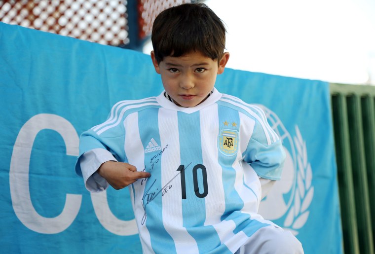 Image: Messi gives Jersey to Afghan Boy