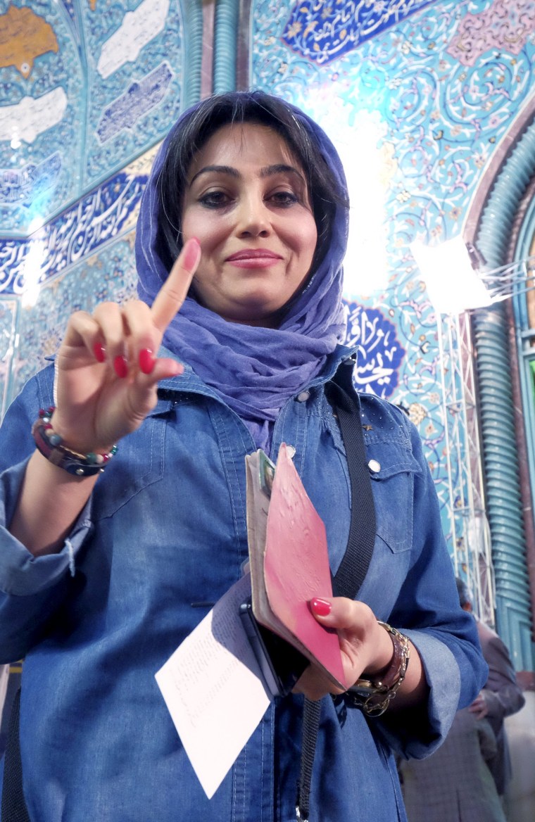 Image: Iranian woman shows her ink-stained finger after voting
