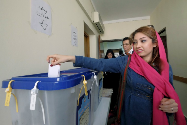 Image: Christian woman casts her ballot at a church during elections for the parliament and Assembly of Experts, in Tehran