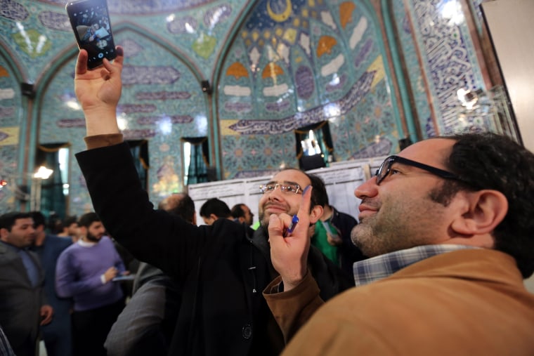 Image: Iranian voters show their ink-stained fingers