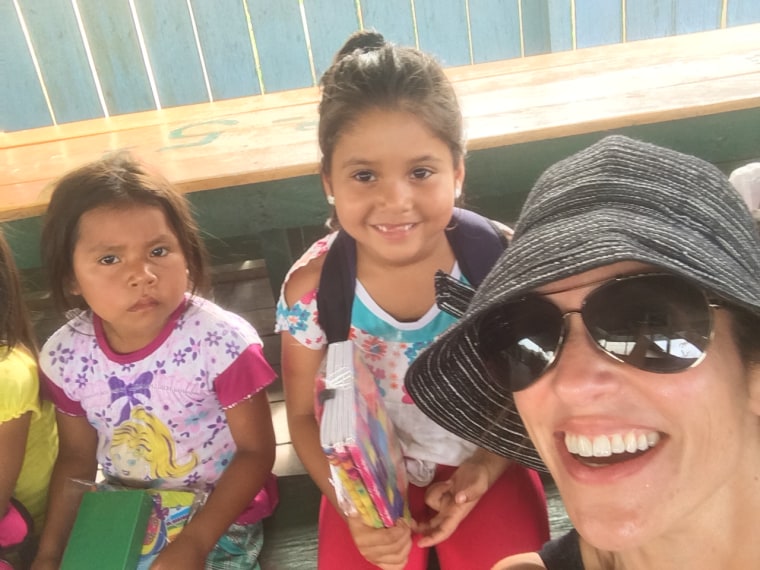 Adrianna Quintero takes a photo of herself and children in the Colombian Amazon.