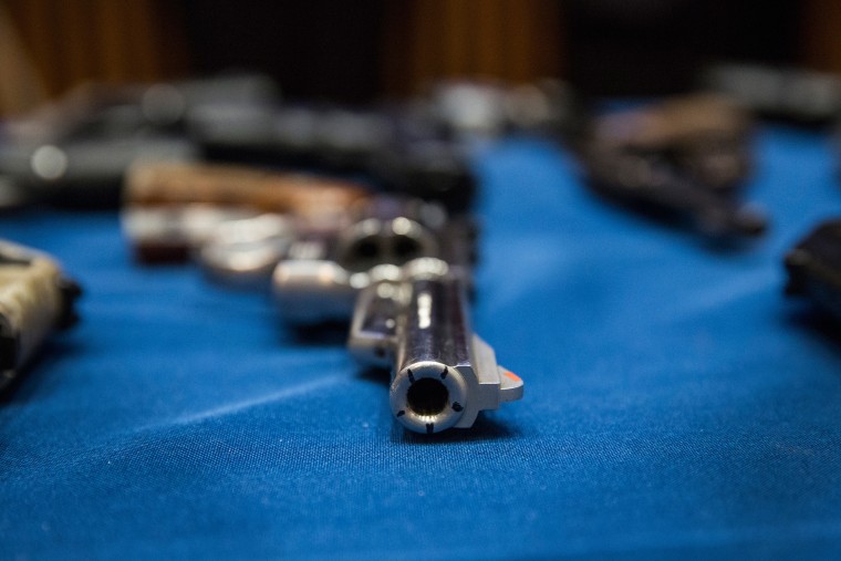 Image: Seized guns on display at a press conference