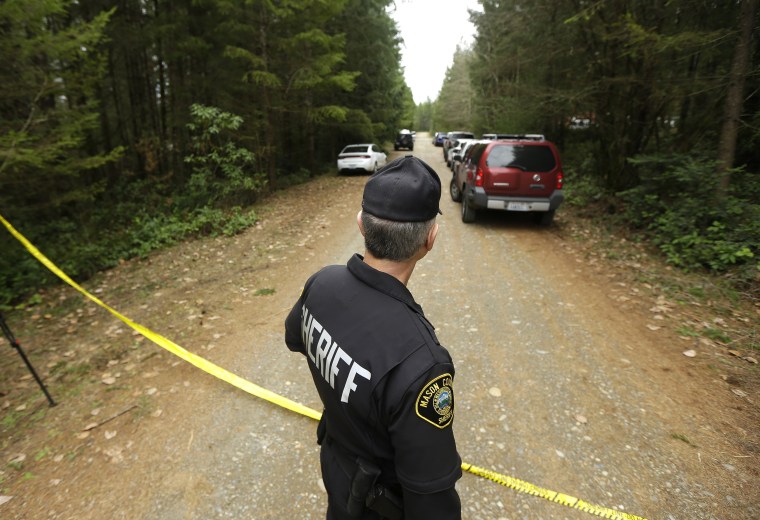 Image: Mason County Sheriff's Chief Criminal Deputy Russ Osterhout looks down a road