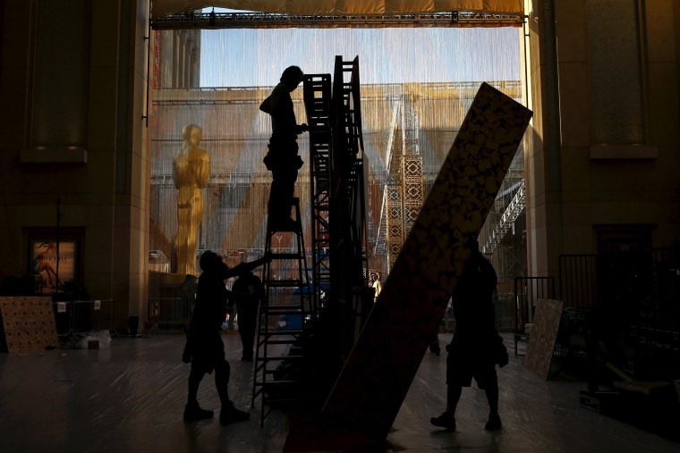 Image: Workers set panels for a backdrop along the red carpet at the Dolby Theatre, the site for the 88th Academy Awards in Hollywood