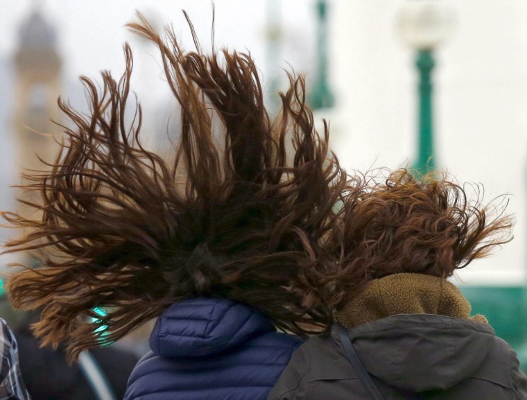 Image: Women walk during a windy weather in San Sebastian