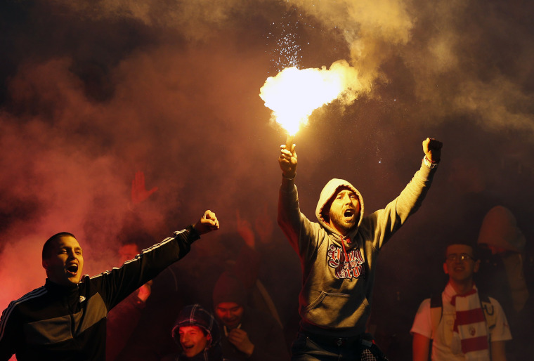 Image: Red Star soccer fans cheer during a Serbian National soccer league derby match
