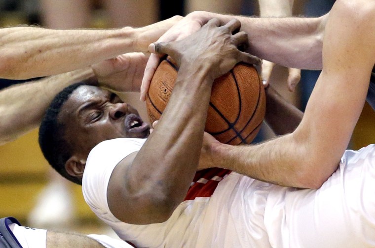 Image: Rutgers forward/center Ibrahima Diallo battles for a loose ball against Northwestern guard Tre Demps