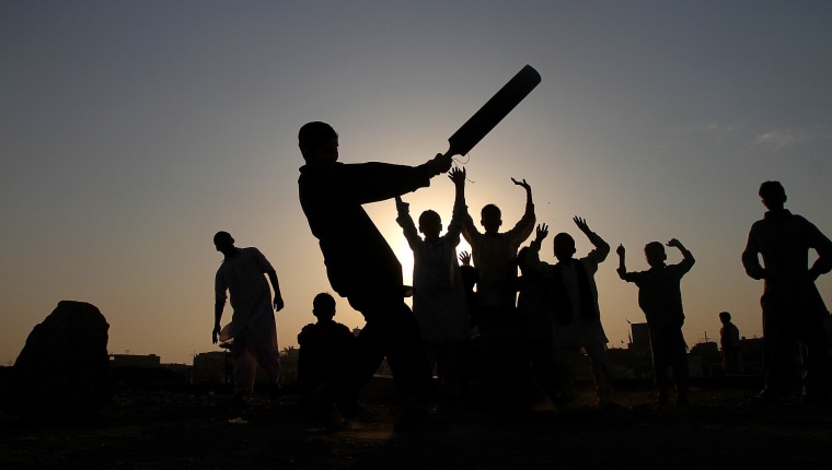 Image: Pakistani youngsters are silhouetted against sunset