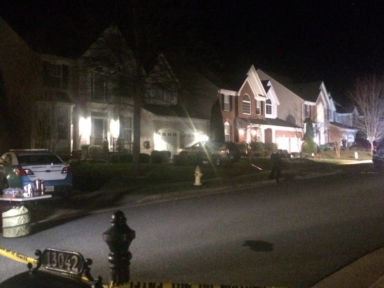 Police remain on the scene late Saturday, Feb. 27, 2016, on Lashmere Court in Dale City, Va., where three Prince William County police officers were shot responding to a domestic violence call.