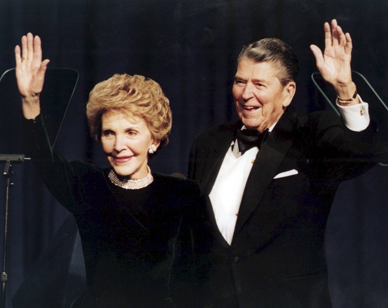 Image: President Ronald Reagan and his wife Nancy wave while attending a gala