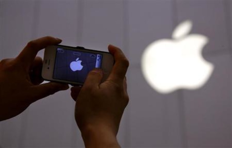A man shows a photograph he took on his iPhone of an Apple store in Beijing