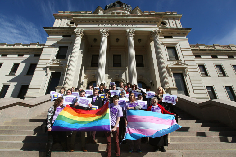 File Photo: Representatives from the Center for Equality, American Civil Liberties Union of South Dakota, LGBT supporters and members of the Human Rights Campaign stand on the front steps of the State Capitol to honor Trans Kids Support Visibility Day in Pierre, S.D. on Tuesday, Feb. 23, 2016. 