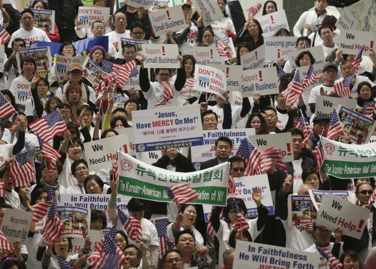 Image: New York nail salon owners and workers wave flags and signs during a small business advocacy rally in the Legislative Office Building on Monday, Feb. 29, 2016, in Albany, N.Y.