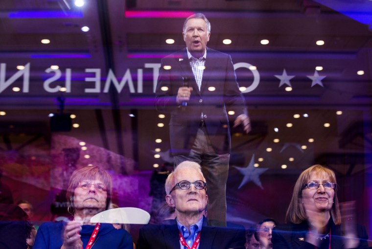 Attendees at the 43rd Annual Conservative Political Action Conference (CPAC) watch Republican presidential candidate John Kasich, seen in a reflection, at the Gaylord National Resort & Convention Center in National Harbor, Maryland. Republican presidential candidates Ted Cruz and Marco Rubio are expected to address the gathering later in the week but Donald Trump has cancelled his planned appearance.