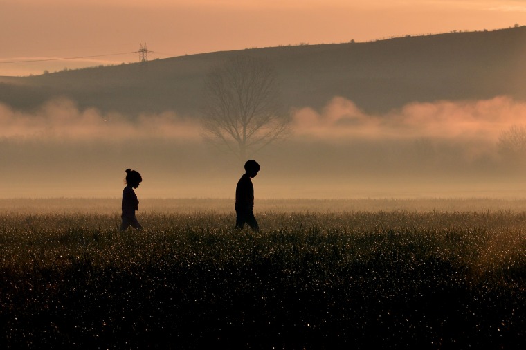 Children walk through a field near a makeshift camp near the Greek village of Idomeni, where thousands of migrants and refugees are stranded along the border with Macedonia. As the diplomatic efforts went into high gear ahead of a March 7 summit between the EU and Turkey, the human misery along the Greek-Macedonia border worsened after a night of driving rain and plummeting temperatures. The humanitarian crisis is particularly acute at the Idomeni crossing where around 12,000 people are stranded after Austria and the Balkan states imposed a cap on entries, triggering a rapidly-growing buildup in Greece.