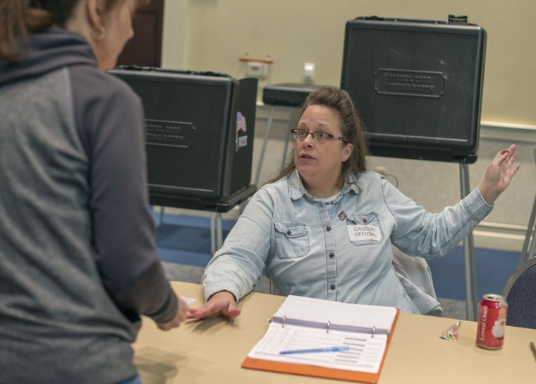 Kentucky's Rowan County Clerk Kim Davis checks in a voter while working the GOP presidential caucus in Morehead, Ky., on Saturday, March 5, 2016. 