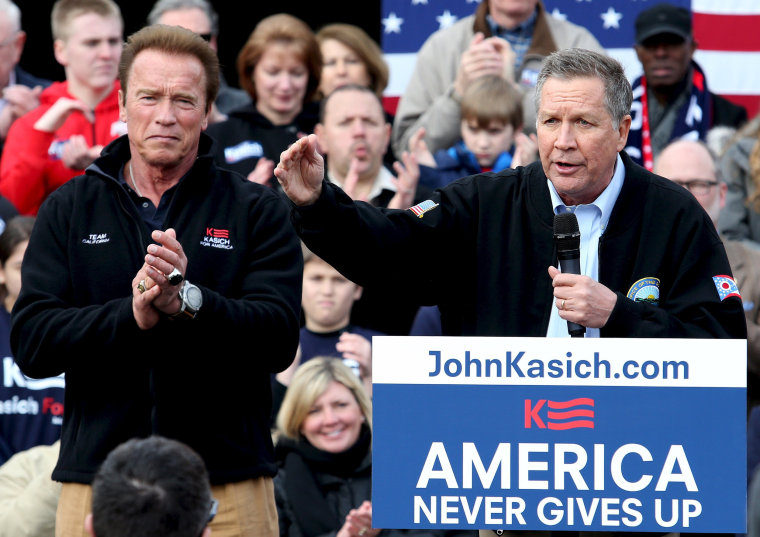 Image: Ohio Governor and Republican U.S. presidential candidate John Kasich speaks at a rally as former California Governor Arnold Schwarzenegger looks on in Columbus