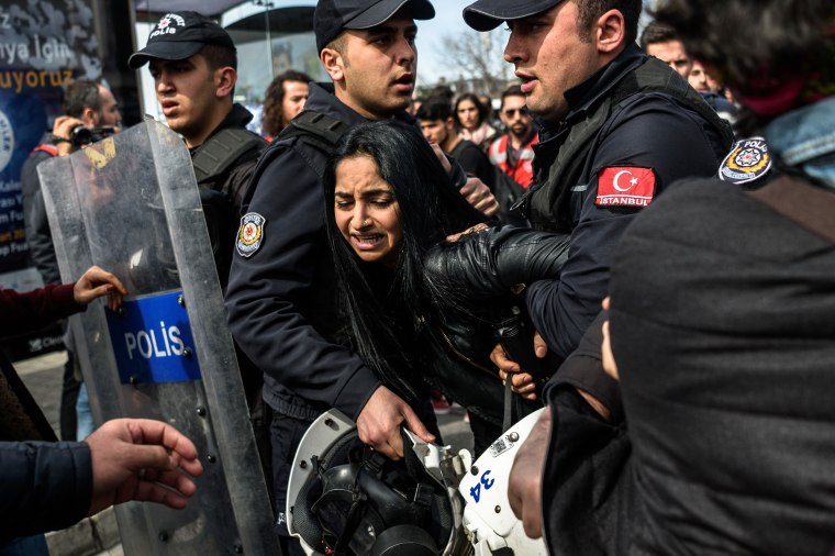 Image: Turkish anti riot police officers detain a woman
