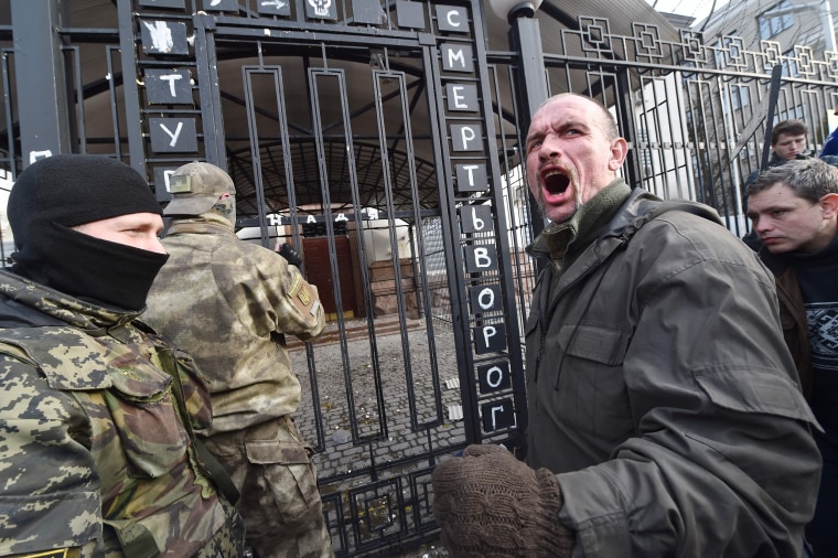 Image: A protester shouts in front of the Russian embassy in Kiev