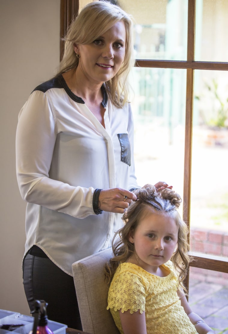 Shelley Gifford and daughter braiding hair