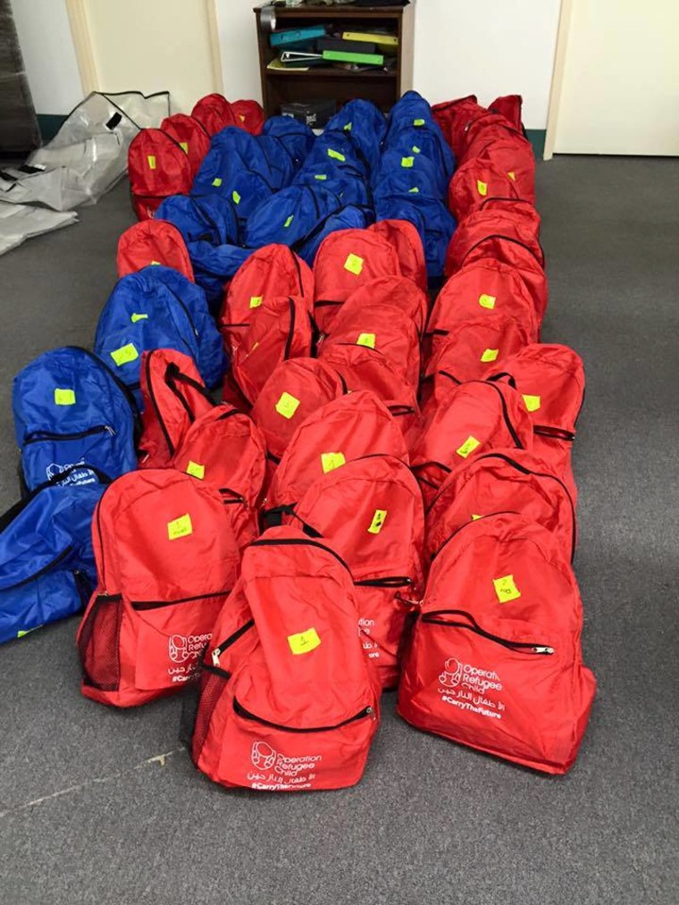 The assembled backpacks await transport to Greece. Each backpack weighs just over 2 pounds and can be worn by an adult or a child.