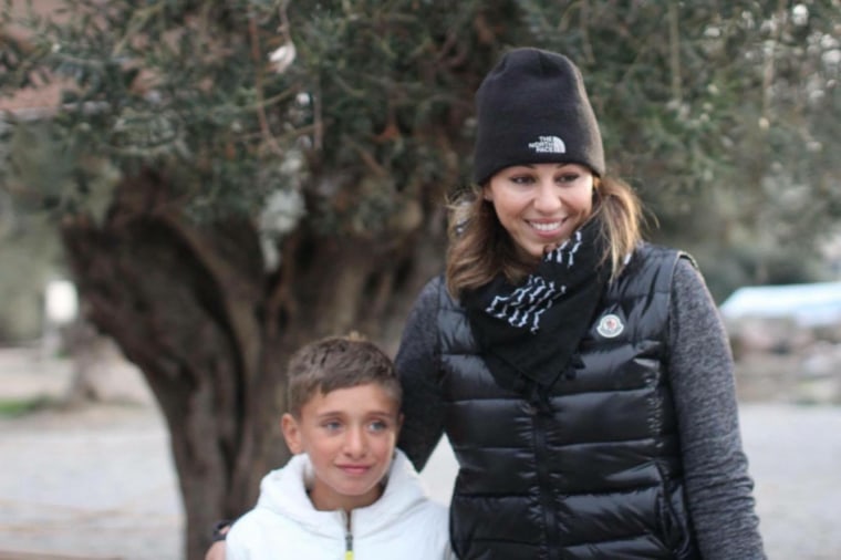 Somer Sood walks with Jamal, a boy from Aleppo, Syria, during her visit to the Kara Tepe camp in Lesvos, Greece.