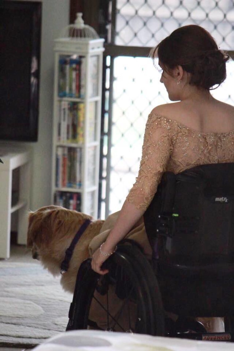 Service dog helps girl get ready for dance