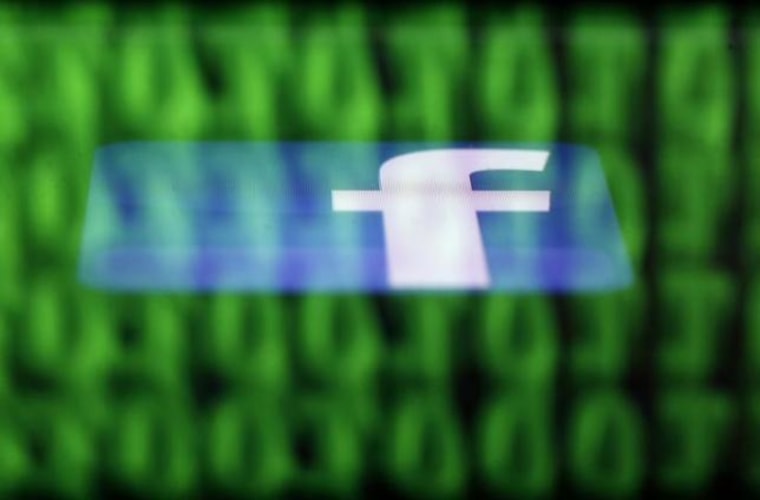A Facebook logo on an Ipad is reflected among source code on the LCD screen of a computer in this photo illustration