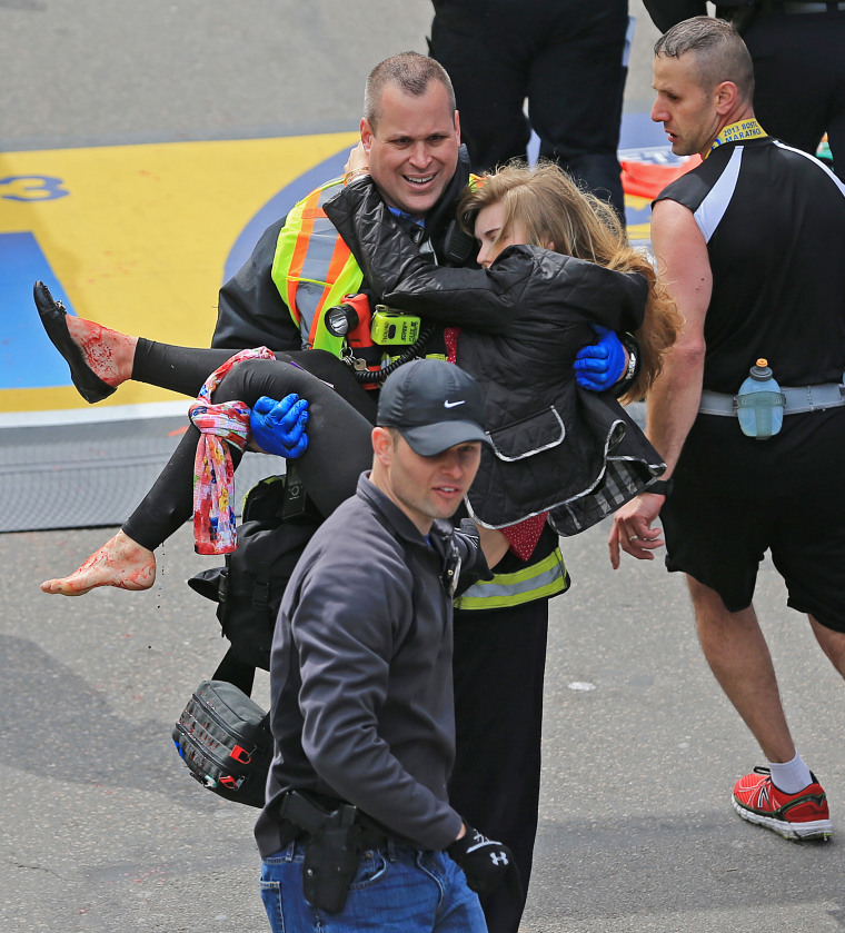 Image: A Boston firefighter carries Victoria McGrath