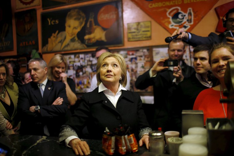 Image: U.S. Democratic presidential candidate Hillary Clinton looks at the menu during a campaign stop at Yesterdog restaurant in Grand Rapids, Michigan,