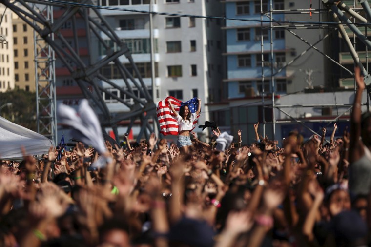 Image: A woman holds a U.S. flag during a performance by U.S. electronic music group Major Lazer in Havana