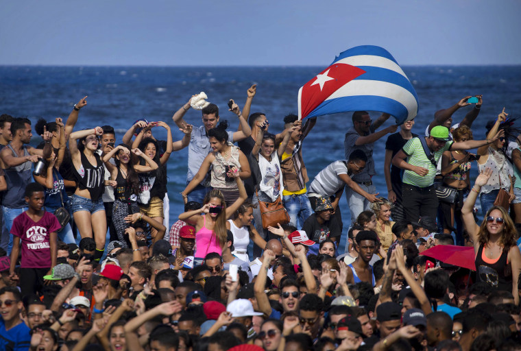 Image: Fans dance on Havana's seafront during a free concert