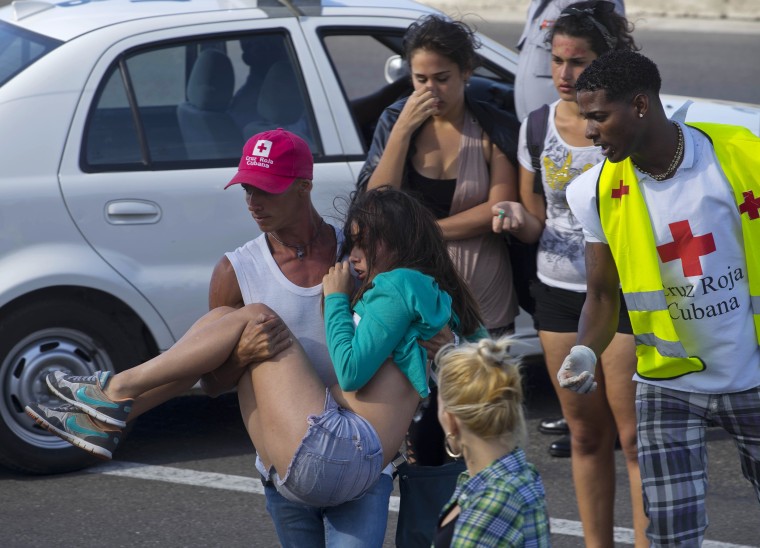 Image: Members of the Cuban Red Cross help a young woman during a free concert