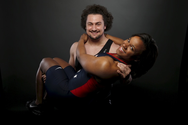 Image: Weightlifter Norik Vardanian (L) lifts his girlfriend, weightlifter Jenny Arthur, as he poses for a portrait at the U.S. Olympic Committee Media Summit in Beverly Hills