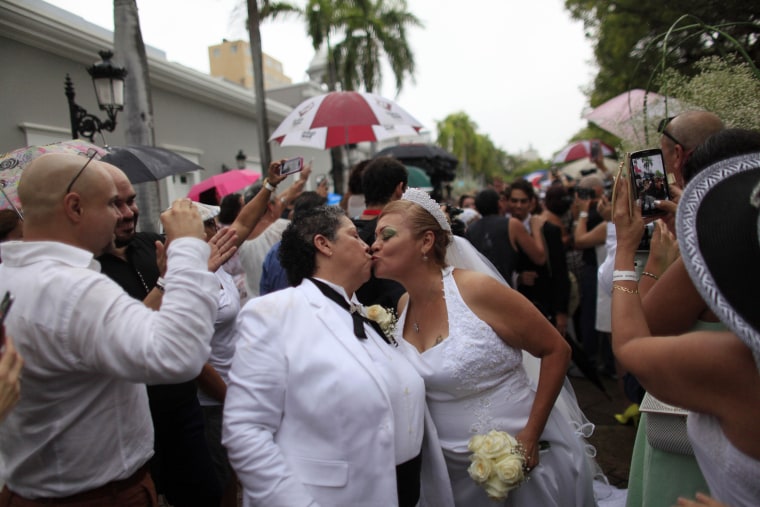 Alma Rosado,left, and Flor Maria Montijo, right, kiss after a mass same-sex wedding in San Juan, Puerto Rico, on Aug. 16, 2015. Over 60 couples from around the region gathered in Puerto Rico’s capital to exchange vows at a same-sex marriage ceremony.