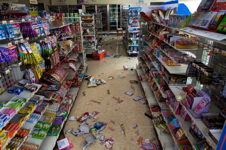 Image: Packaged items lie on the floor of a convenience store in Futaba, Japan