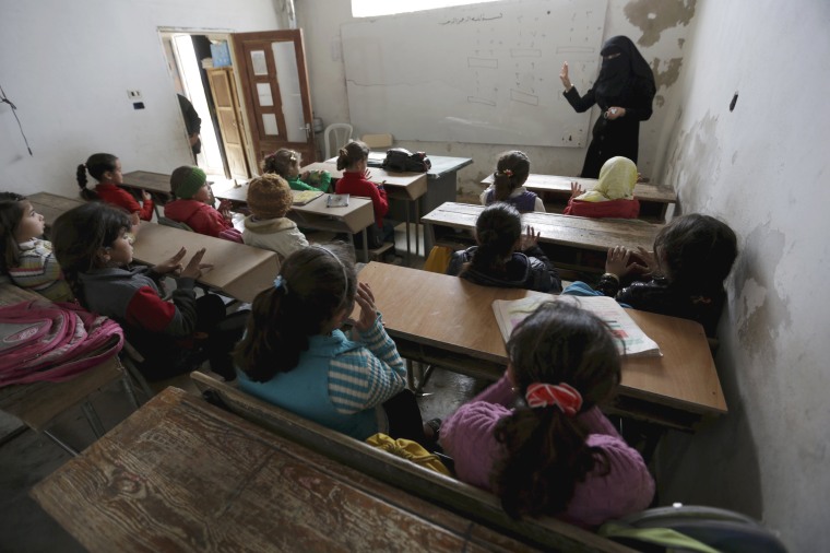 Image: Students attend a class inside the Freedom School, in the town of al-Tamanah, in the southern countryside of Idlib