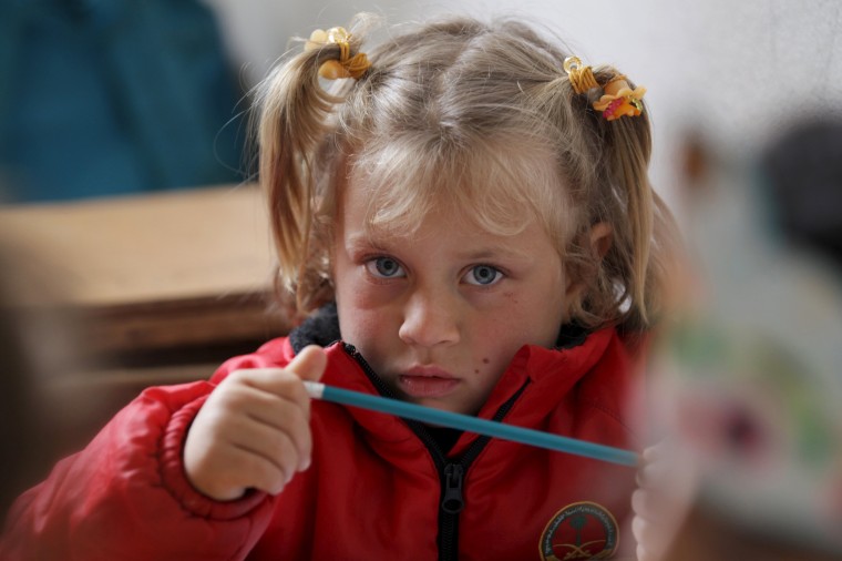 Image: A student attends a class inside the Freedom School, in the town of al-Tamanah, in the southern countryside of Idlib