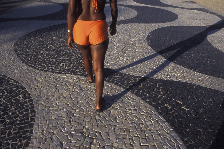 View from behind of young black woman walking at