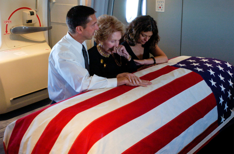 Nancy Reagan and her son Ron and his wife Doria at Ronald's coffin.